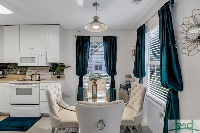 dining space with light tile patterned floors