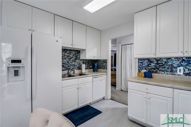 kitchen featuring white cabinets, tasteful backsplash, white appliances, and sink