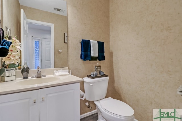 bathroom featuring toilet and vanity