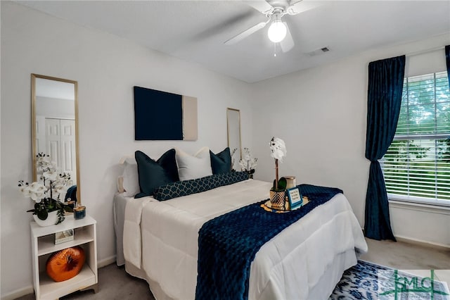 carpeted bedroom with ceiling fan