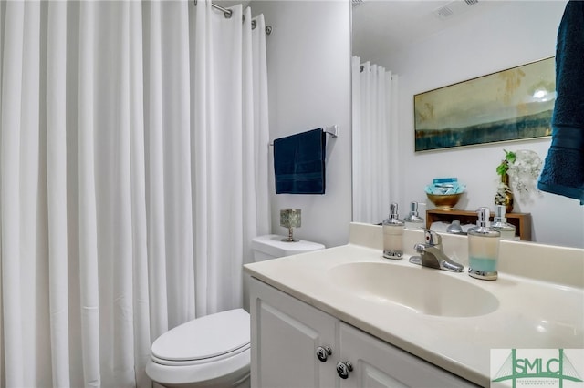 bathroom with toilet and vanity