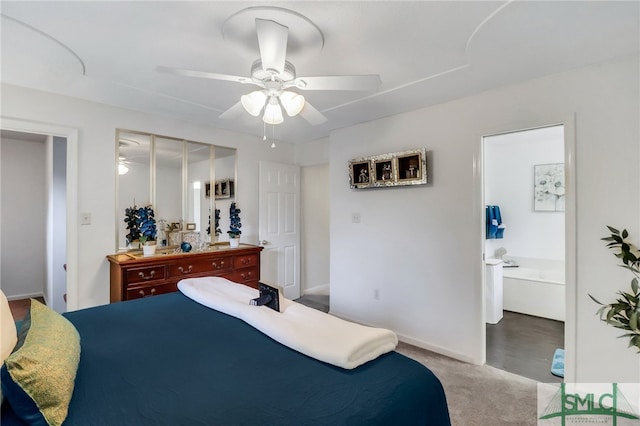 bedroom featuring ensuite bathroom, ceiling fan, light carpet, and a closet