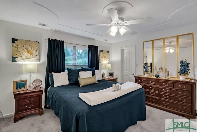 bedroom with ceiling fan, light carpet, and a closet