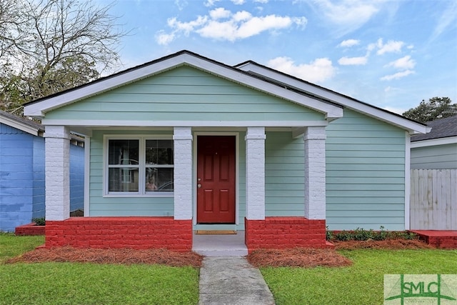 bungalow featuring a front lawn and covered porch