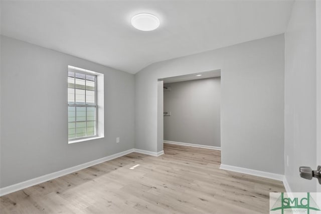 705 W 47th St, Savannah, GA 31405 - unfurnished bedroom with wood finished floors, baseboards, and vaulted ceiling