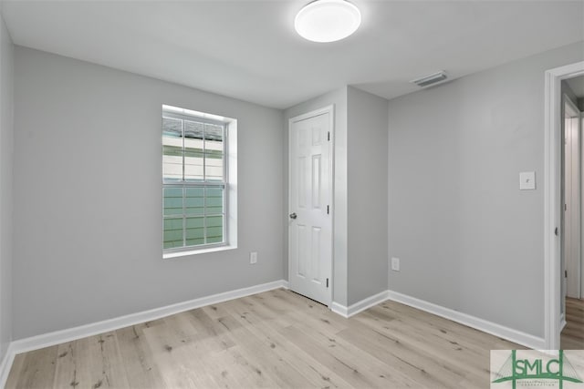 unfurnished bedroom featuring a closet and light wood-type flooring