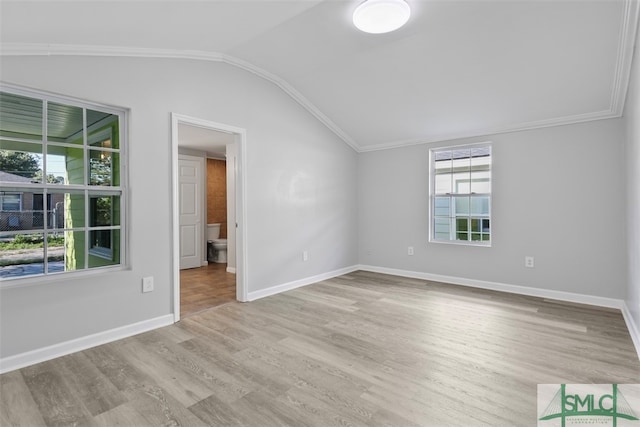 unfurnished room featuring light wood-type flooring, lofted ceiling, and crown molding