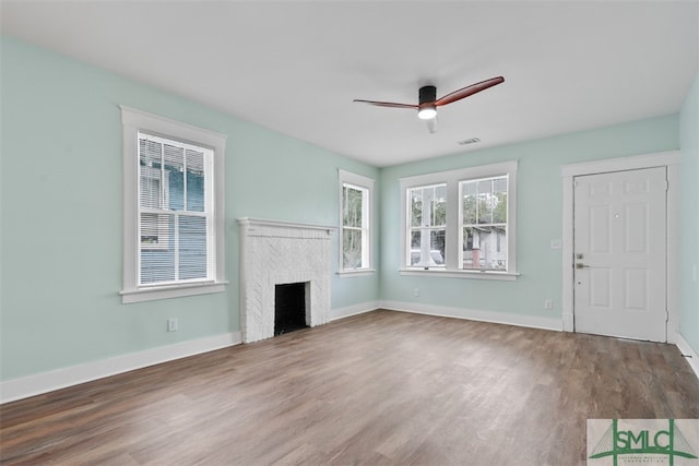 unfurnished living room featuring hardwood / wood-style flooring and ceiling fan