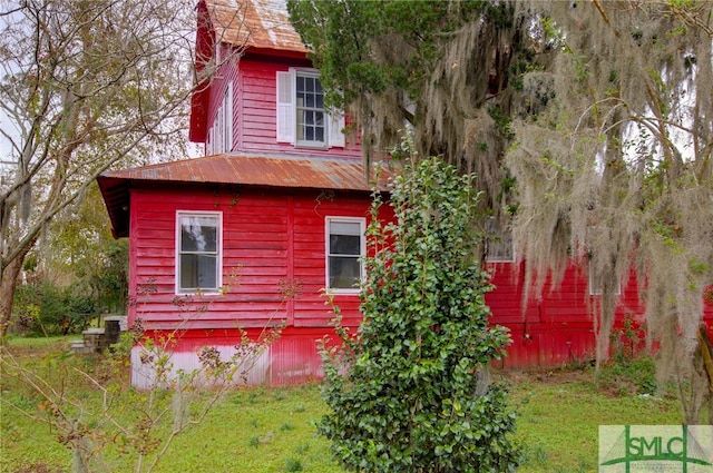 view of property exterior with a yard