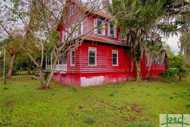 view of home's exterior with a yard