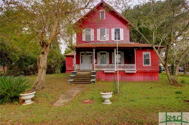 view of front of home featuring a front lawn and a porch