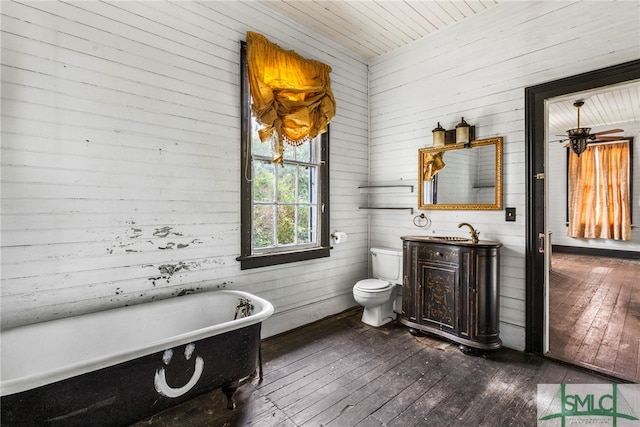 bathroom featuring wood walls, a tub to relax in, wood ceiling, and wood-type flooring