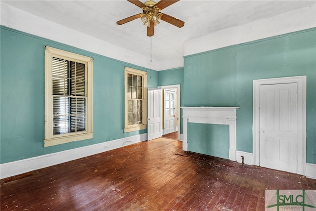 unfurnished living room featuring ceiling fan and wood-type flooring