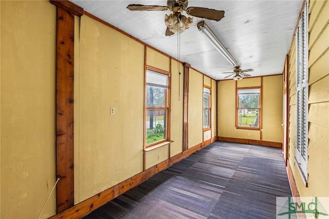 unfurnished sunroom featuring plenty of natural light and ceiling fan