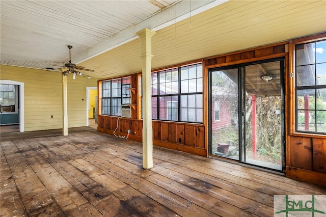 unfurnished sunroom with a wealth of natural light, wooden ceiling, and ceiling fan