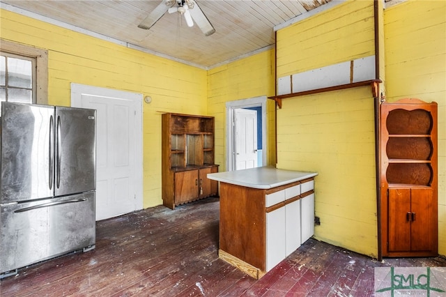 kitchen with stainless steel refrigerator, dark hardwood / wood-style floors, wood walls, wood ceiling, and ceiling fan