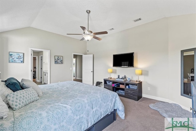 carpeted bedroom featuring ensuite bathroom, ceiling fan, and vaulted ceiling