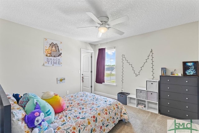 carpeted bedroom featuring ceiling fan and a textured ceiling