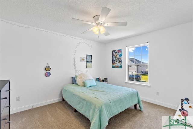 carpeted bedroom with ceiling fan and a textured ceiling