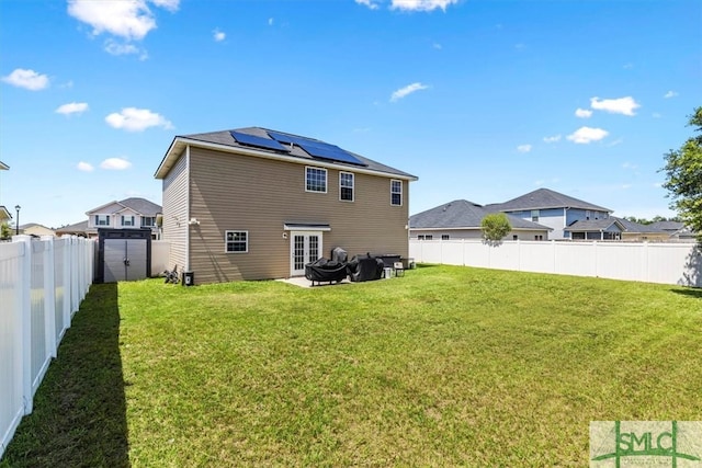 rear view of house featuring a yard and a patio area