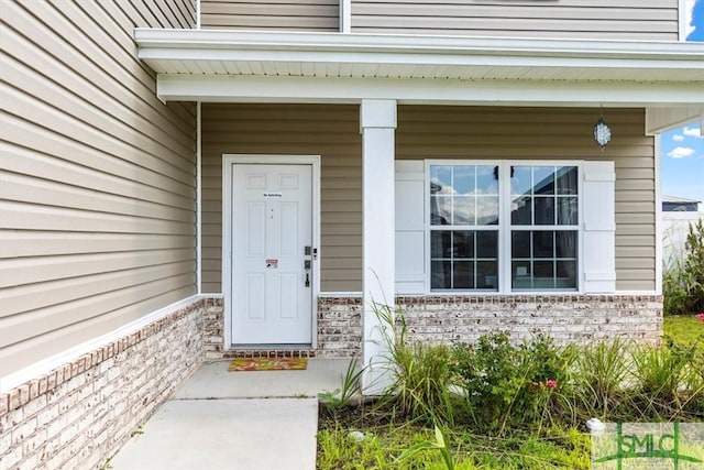 doorway to property featuring covered porch