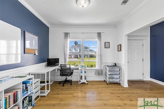 home office with a textured ceiling, hardwood / wood-style flooring, and crown molding