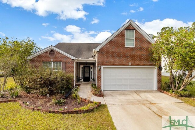 view of front of home with a garage and a front yard