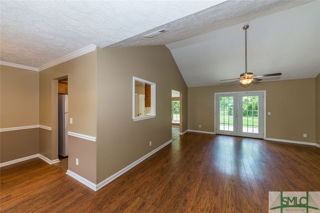 unfurnished room with a textured ceiling, crown molding, dark wood-type flooring, and french doors