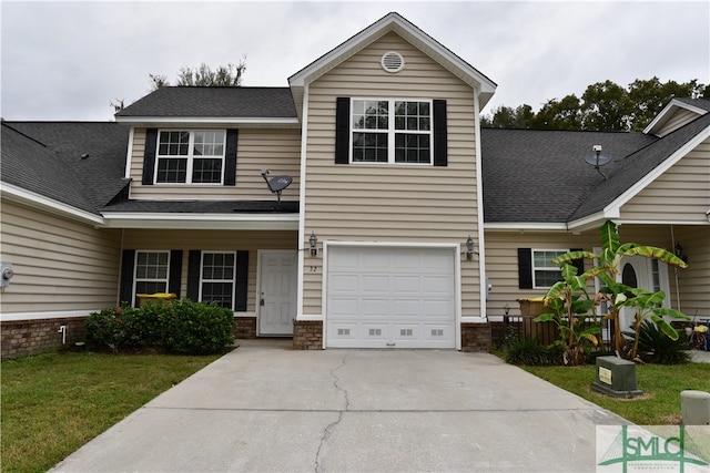 view of front of home with a garage and a front yard