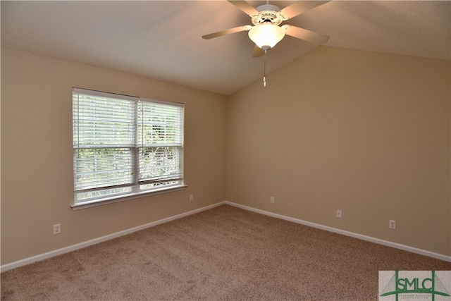 carpeted empty room with vaulted ceiling and ceiling fan