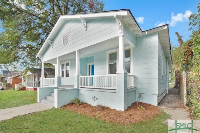 bungalow-style home featuring a front yard and a porch