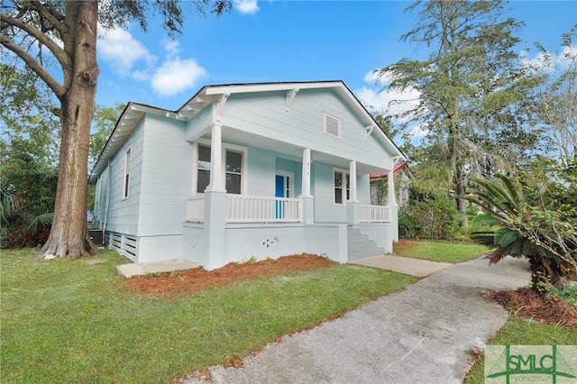 bungalow-style home featuring a front yard and covered porch