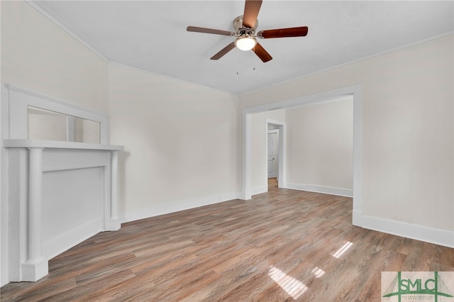 unfurnished living room featuring hardwood / wood-style floors, ceiling fan, and crown molding