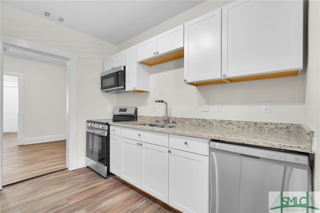 kitchen with white cabinetry, appliances with stainless steel finishes, light stone countertops, sink, and light hardwood / wood-style flooring