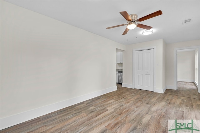 unfurnished bedroom with a closet, ceiling fan, and light hardwood / wood-style flooring