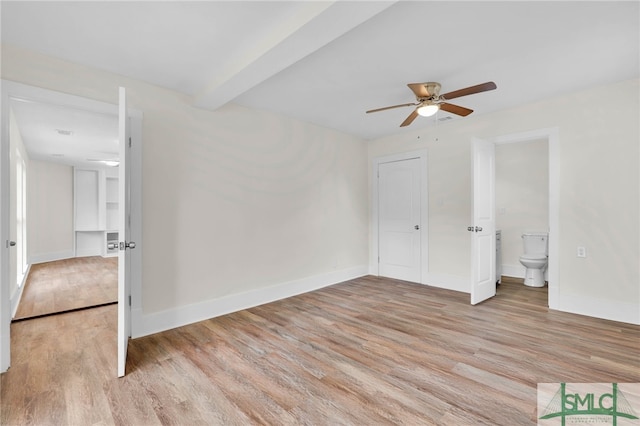 unfurnished bedroom featuring connected bathroom, light hardwood / wood-style floors, and ceiling fan