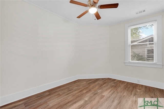 unfurnished room featuring ceiling fan, light hardwood / wood-style floors, and crown molding