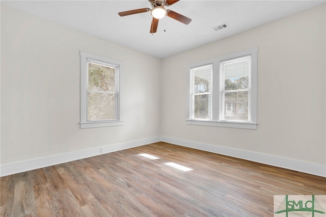 empty room featuring ceiling fan and light hardwood / wood-style floors