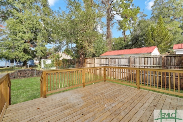 wooden terrace featuring a yard