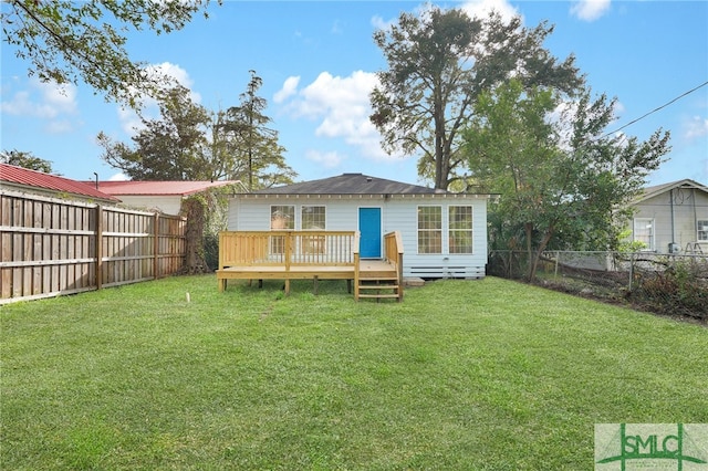 back of house featuring a yard and a deck