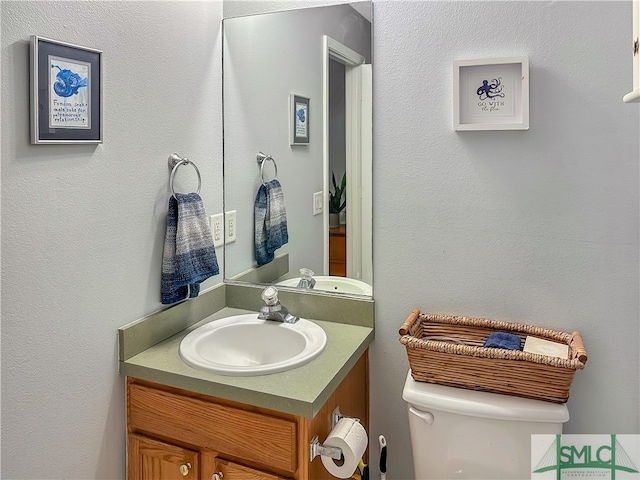 bathroom featuring toilet and vanity