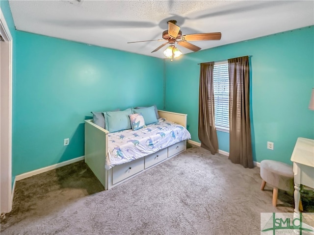 carpeted bedroom featuring ceiling fan and a textured ceiling