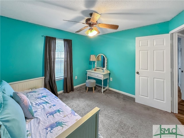 bedroom with carpet, a textured ceiling, and ceiling fan