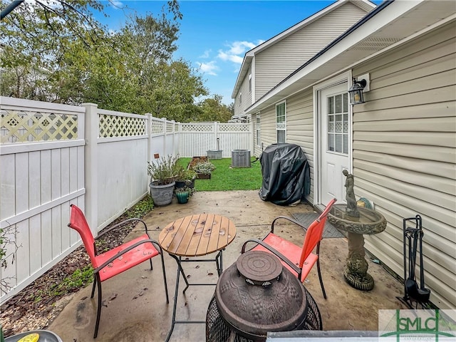 view of patio / terrace with cooling unit, an outdoor fire pit, and a grill