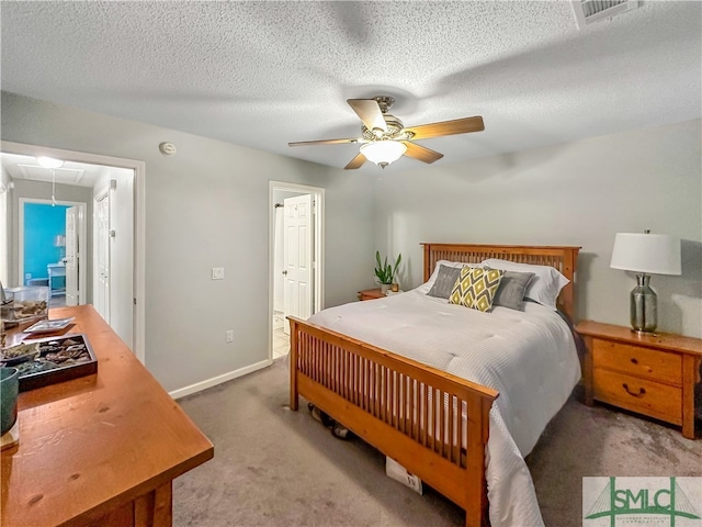 carpeted bedroom featuring a textured ceiling and ceiling fan