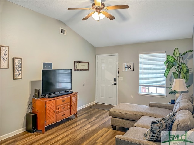 living room featuring lofted ceiling, dark hardwood / wood-style floors, and ceiling fan