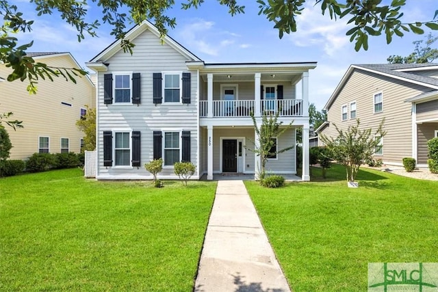 view of front facade with a balcony and a front yard