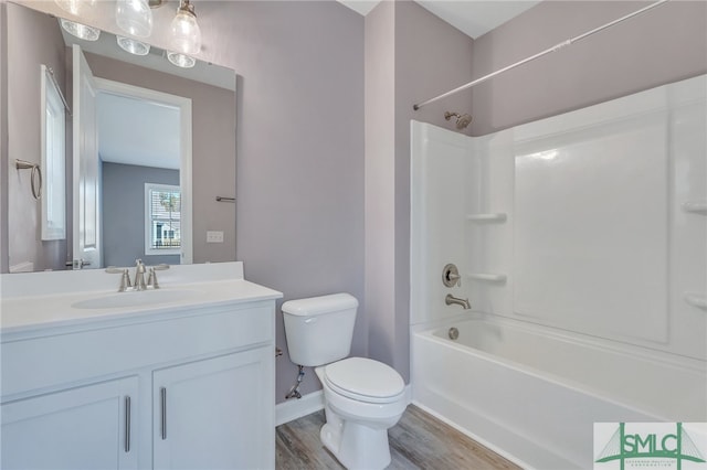 full bathroom featuring vanity, wood-type flooring, toilet, and tub / shower combination