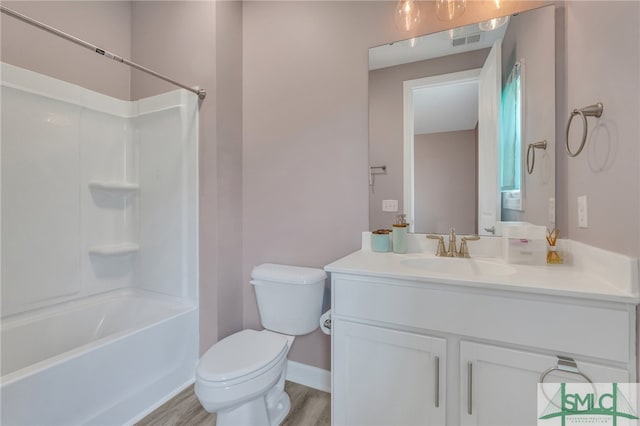 full bathroom featuring vanity, wood-type flooring, toilet, and  shower combination