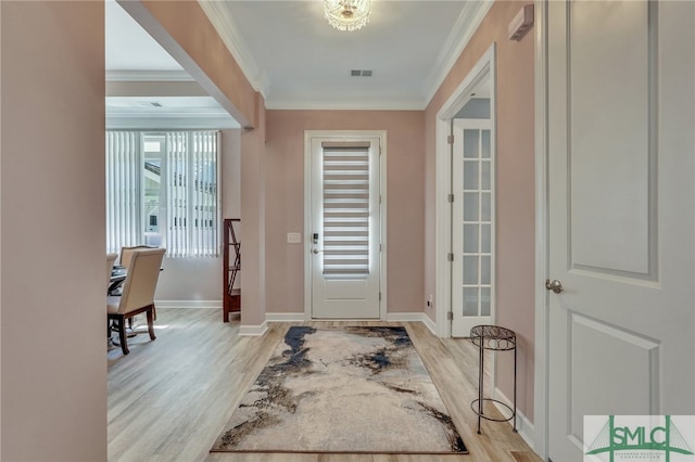 entrance foyer with light hardwood / wood-style floors and ornamental molding